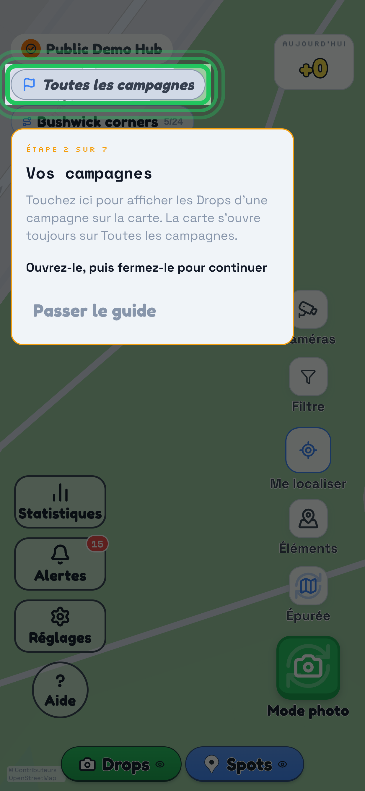 Une visite guidée sur la carte de TraceReach Drop, avec tout l’écran assombri. Le repère entoure la pastille de campagne Première vague du quartier, elle-même entourée par l’anneau de la visite. La fiche dessous affiche Étape 2 sur 7, Vos campagnes, puis Touchez ici pour choisir la campagne correspondant aux supports que vous emportez, Ouvrez puis fermez pour continuer et Passer la visite.
